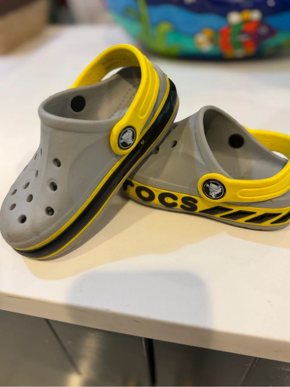 CROCS Kids Gray Clogs with Yellow Heel Strap